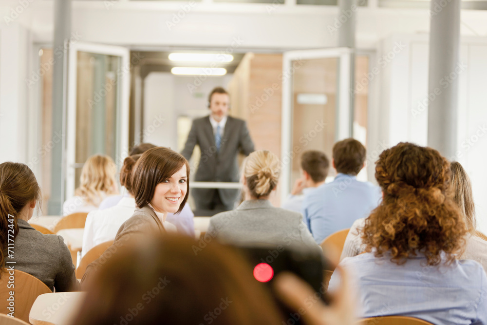 Motivational speaker and business coach holding a business coaching seminar for young professionals at a start-up business. Motivational speaker and business coach holding a business coaching seminar for young professionals at a start-up business.