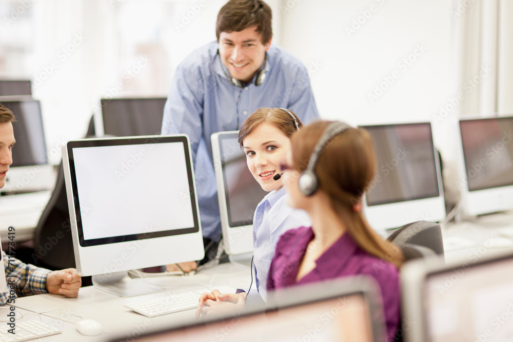 Colleagues working in a call center with a very friendly atmosphere. Munich, Germany Colleagues working in a call center with a very friendly atmosphere. Munich, Germany