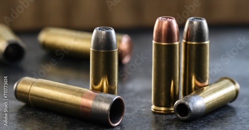 Closeup of modern ammunition, featuring 9mm bullets with copper jackets. The dark and reflective background enhances the dangerous and lethal essence of these firearm projectiles.