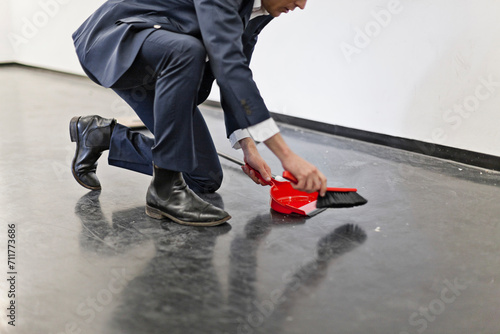 Man dressed in a suit cleaning hall way in an office. Munich, Bavaria, Germany photo