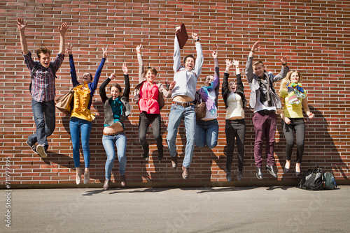Group of students on campus jumping for joy. Munich Germany photo