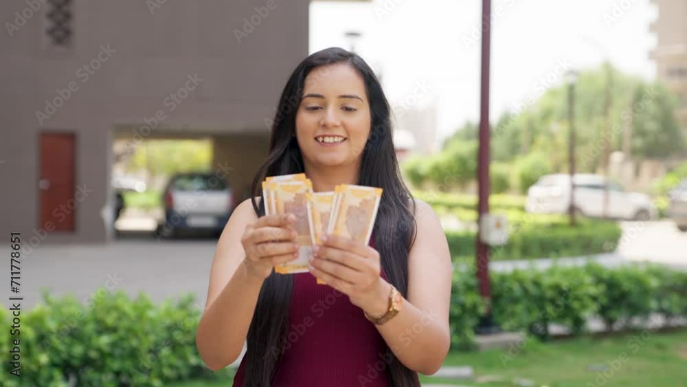 Indian Woman counting money, 200 Indian Rupees Indian Woman counting money, 200 Indian Rupees
