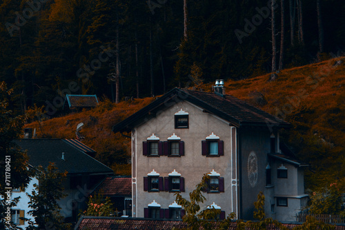 Autumnal Alpine Elegance: A Heritage House Against the Fiery Hues of a Forested Hillside