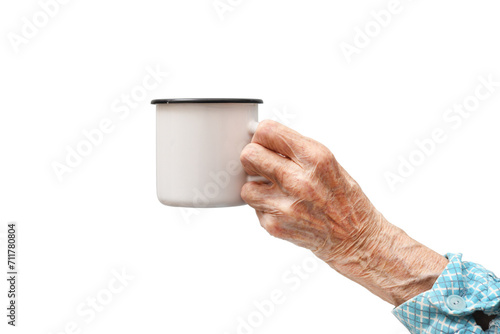A woman holds a mug in her hand.Rheumatoid polyarthritis of the hand of a 95-year-old woman, isolated on a white background.  photo