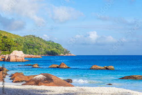 Coastal rocks and blue ocean. Anse Lazio beach on a sunny day, landscape of Praslin. Seychelles