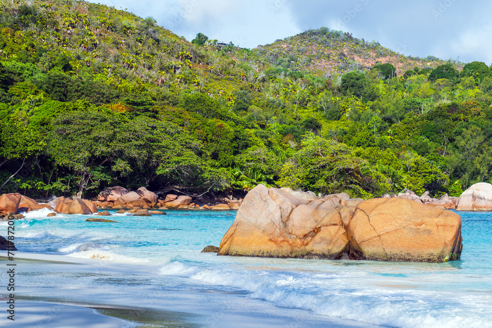 Landscape of Anse Lazio beach with coastal rocks and shore water, Praslin, Seychelles