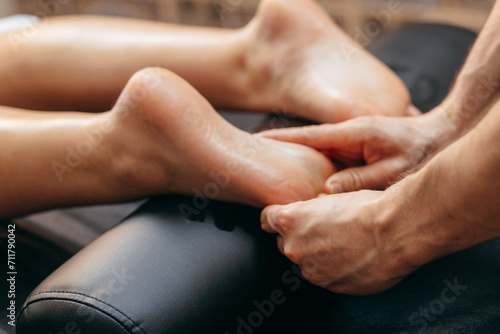 Close up male hands doing foot massage 