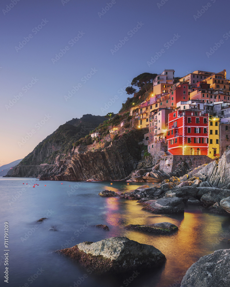 Riomaggiore town, cape and sea at sunset. Cinque Terre, Liguria, Italy
