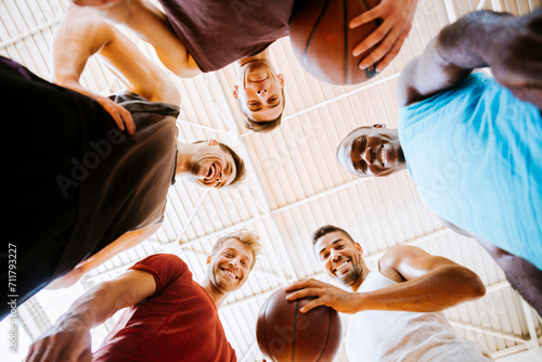 Young men in team huddle at basketball indoor gym photo