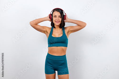 Athletic woman with healthy body listening to music