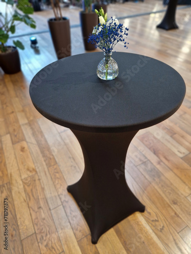 For a more luxurious look   bistro table can be covered with a white or black stretch tablecloth. will add spice to any wedding or corporate event. a vase with a flower from florist shop  store