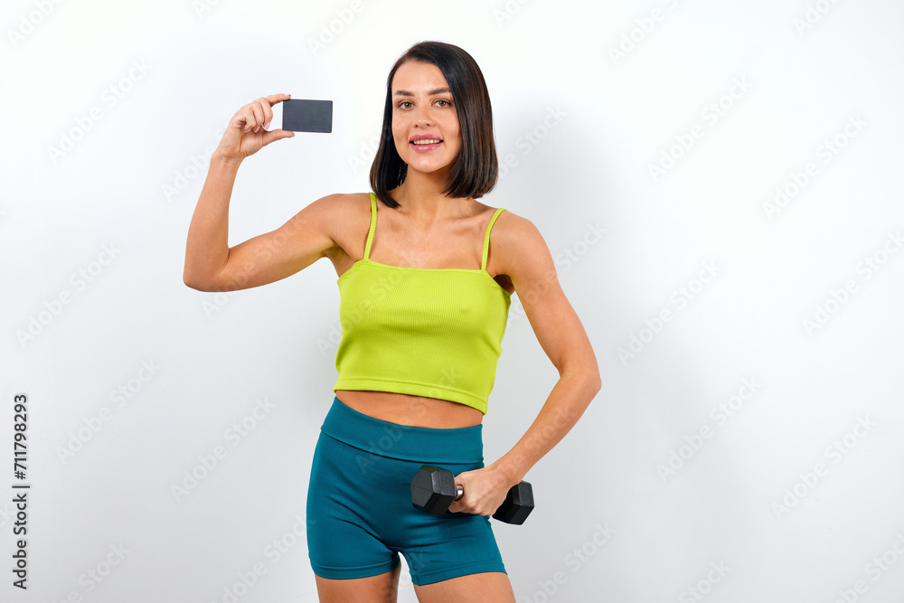 Fitness trainer woman holding plastic card with mockup Fitness trainer woman holding plastic card with mockup