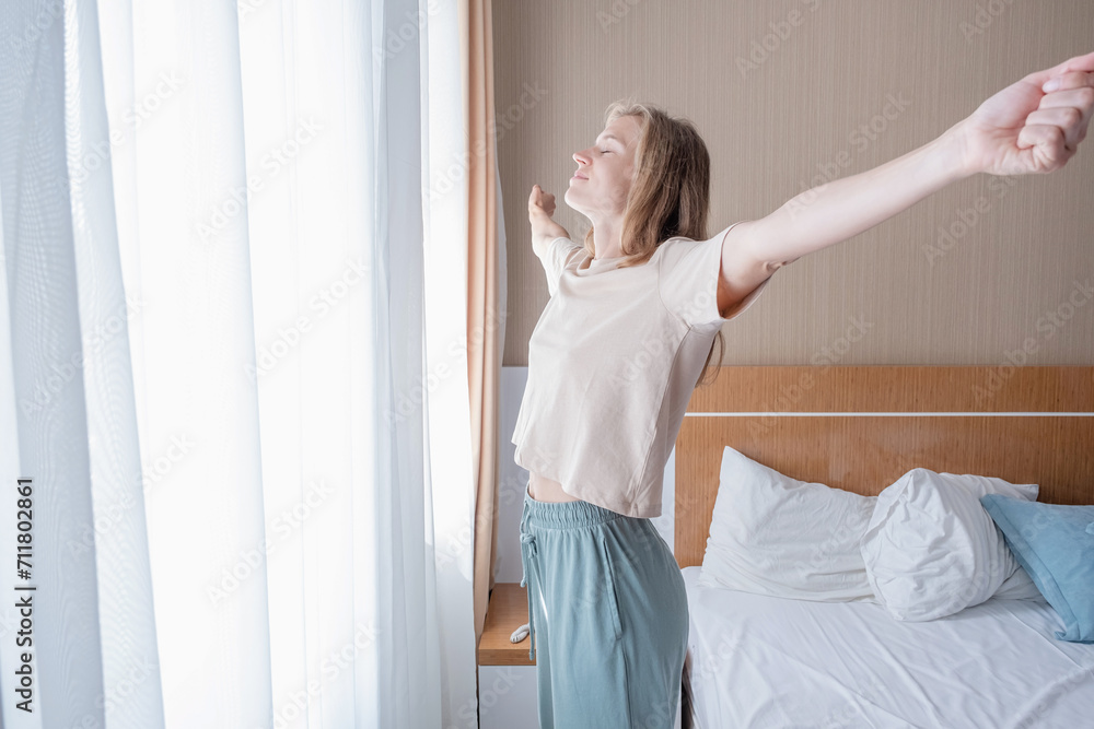 Young woman waking up and stretching in the morning Young woman waking up and stretching in the morning
