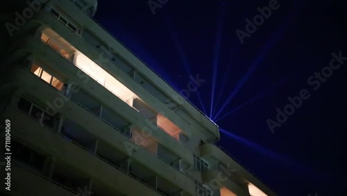 Building with balconies with illumination at summer night photo