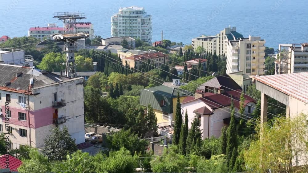 Cableway and buildings among trees in small resort town Cableway and buildings among trees in small resort town