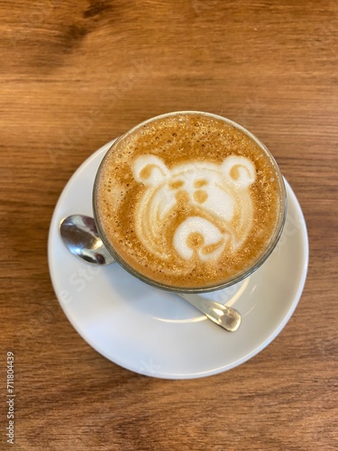 Cup of coffee with foam in the form of a bear design.