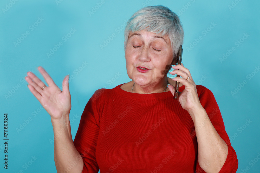 Isolated 60s woman talking on mobile phone Isolated 60s woman talking on mobile phone