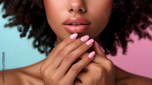 black woman with makeup and pink manicure photo