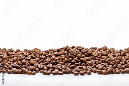 Coffee beans scattered on a white isolated background for a banner.