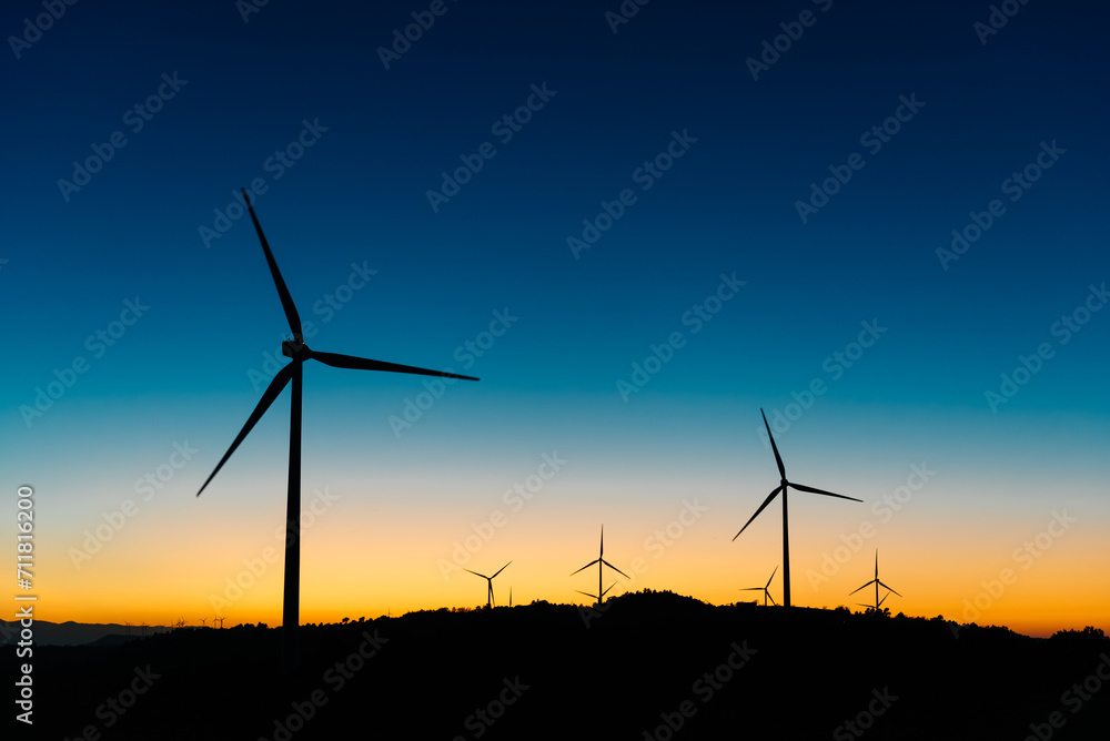 Wind turbines on field at sunset Wind turbines on field at sunset