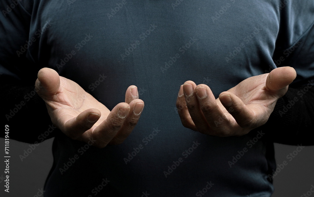 Obraz premium man praying to god Caribbean man praying with black grey background with people stock photo