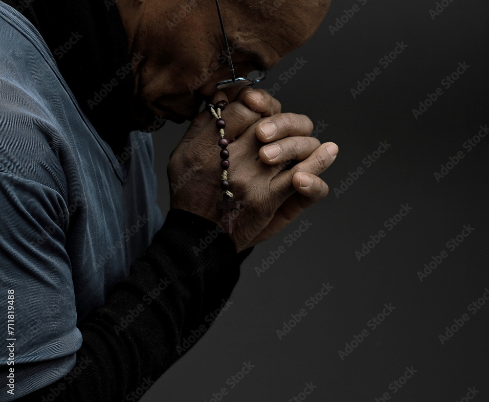 man praying to god Caribbean man praying with black grey background with people stock photo	
