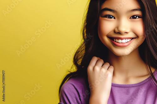 Smiling girl on a clean background. Space for text. © Andbiz