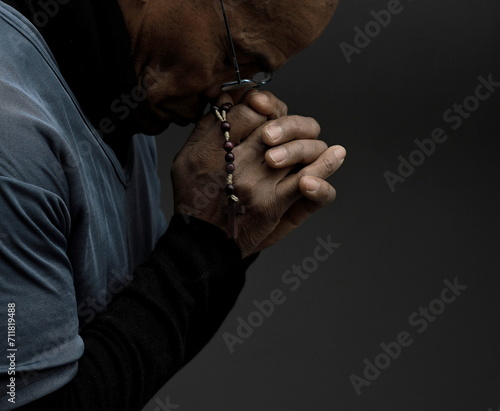 man praying to god Caribbean man praying with black grey background with people stock photo 