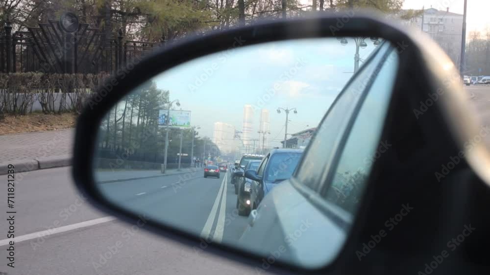 Traffic jam and moving cars are reflected in mirror of car Traffic jam and moving cars are reflected in mirror of car