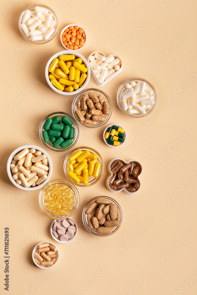 Tablets, capsules, pills, food supplements, minerals in small plates from above on a light beige background. Meds and vitamins to avoid illnesses to have a good health. Prevention of illness. Tablets, capsules, pills, food supplements, minerals in small plates from above on a light beige background. Meds and vitamins to avoid illnesses to have a good health. Prevention of illness.