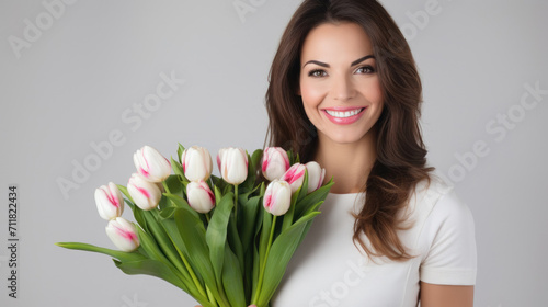beautiful young girl model with a bouquet of tulip flowers, international women's day, warm relationship care and attention