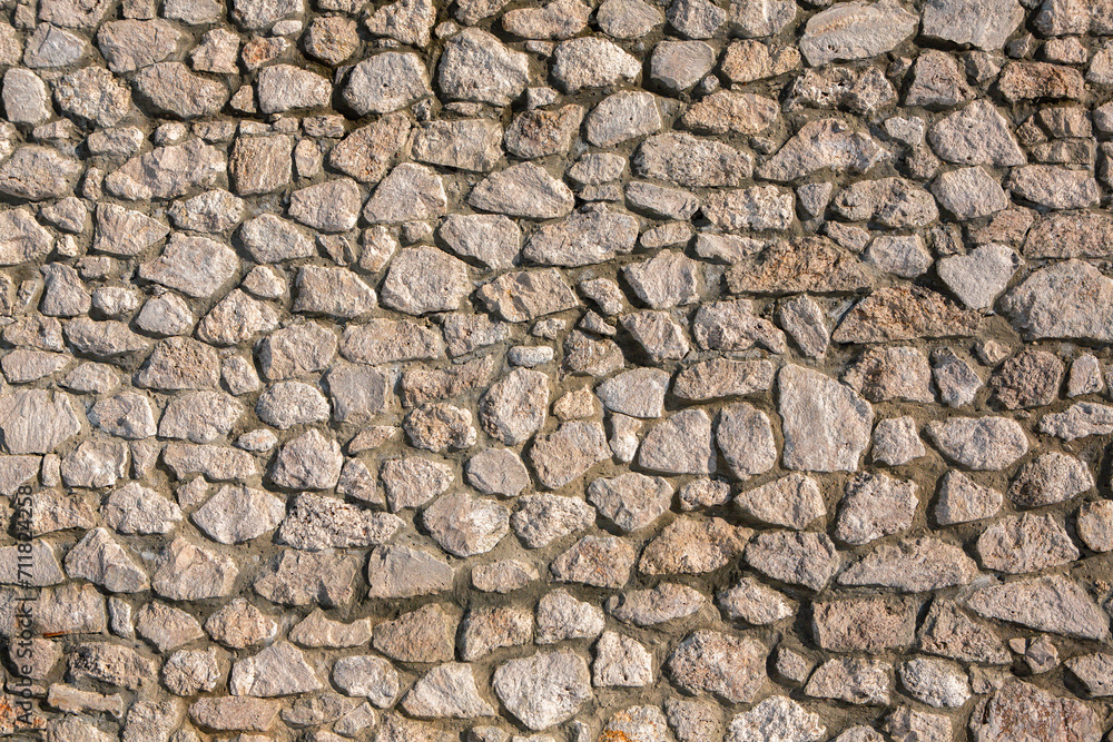 Background of stone wall texture photo. Close-up of stone wall. Background of stone wall texture photo. Close-up of stone wall.