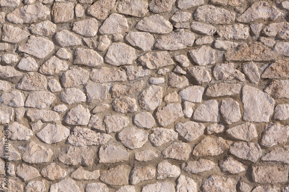 Background of stone wall texture photo. Close-up of stone wall. Background of stone wall texture photo. Close-up of stone wall.
