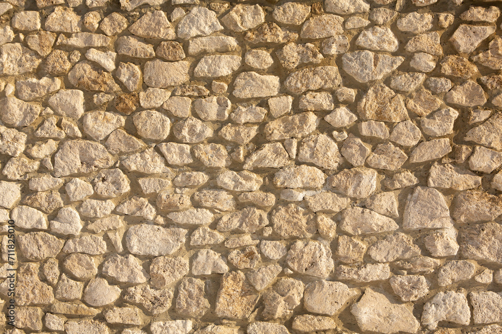 Fototapeta premium Background of stone wall texture photo. Close-up of stone wall.