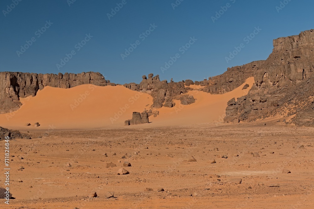 View of rock formations and Dunes of Ouan Zaoutan, sand dunes in Tadrart Rouge, Tassili n Ajjer National Park. Sahara, Algeria, Africa.