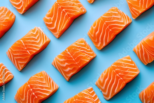 top view of sliced raw salmon fillets on blue background