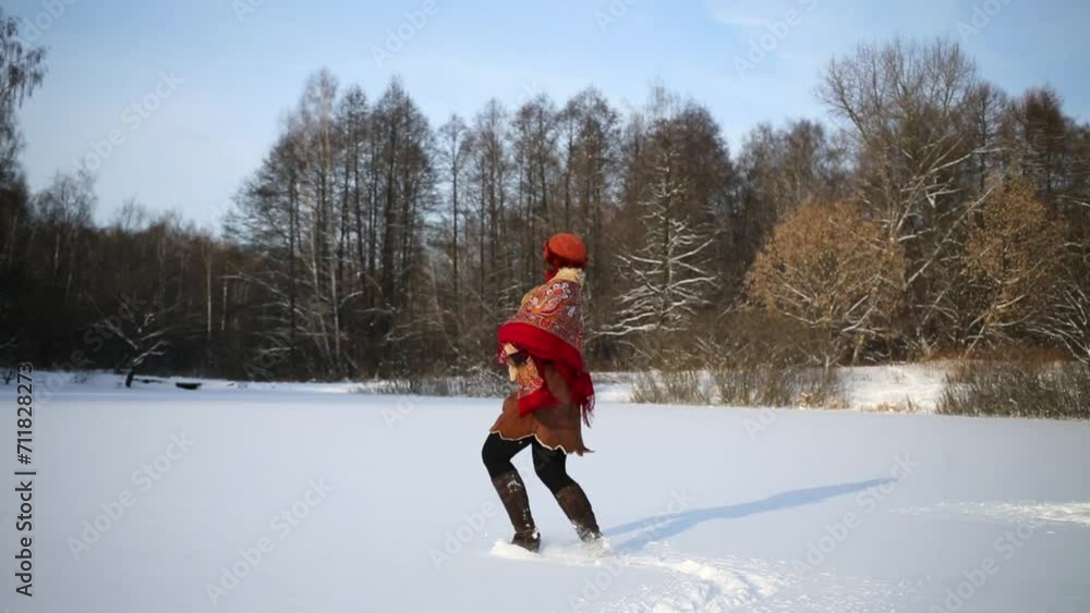woman runs through snowy glade and dances spinning round herself. woman runs through snowy glade and dances spinning round herself.
