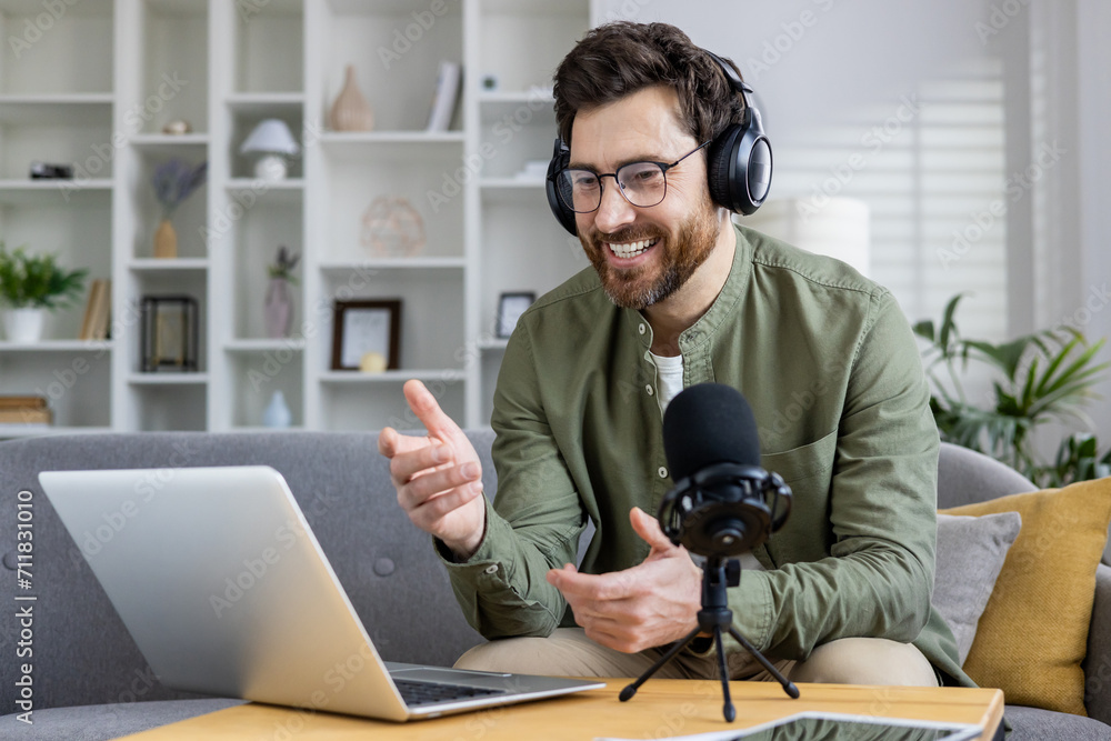 Cheerful male podcaster recording content in a cozy home office, using laptop and professional audio equipment. Cheerful male podcaster recording content in a cozy home office, using laptop and professional audio equipment.