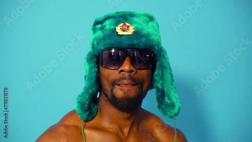 Face of black half-naked man in cap and sunglasses dancing  photo