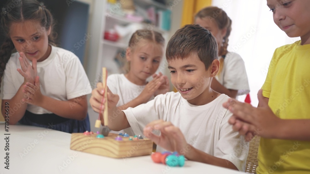 child boy group playing fishing. a group of children collect building blocks in a kindergarten indoors. children in kindergarten play with toys. happy family lifestyle kid dream concept child boy group playing fishing. a group of children collect building blocks in a kindergarten indoors. children in kindergarten play with toys. happy family lifestyle kid dream concept