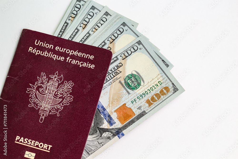 Closeup view of french passport and us dollar banknotes. Closeup view of french passport and us dollar banknotes.