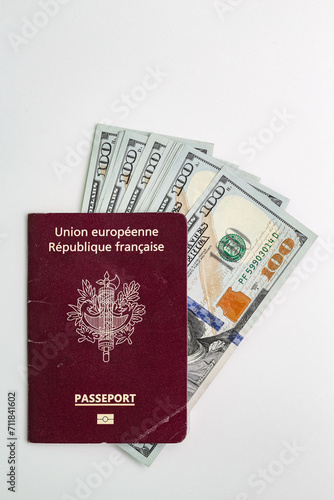 Closeup view of french passport and us dollar banknotes.