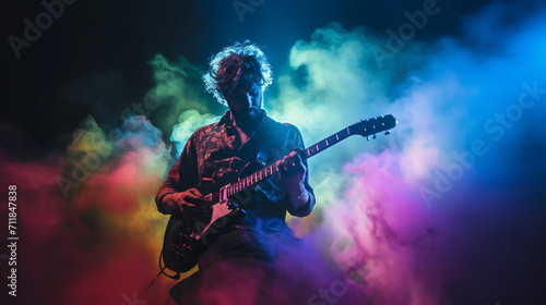 A guitar player making rock during concert. Rock band performs on stage. Guitarist plays solo. photo