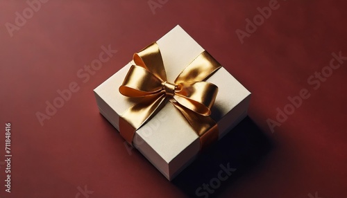 blank gold ribbon bow gift box open or top view of white present box tied with golden bow on dark red background with shadow minimal conceptual 3d rendering