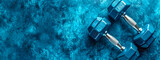 pair of blue hexagonal dumbbells on a textured blue background, conveying themes of strength, fitness, and physical exercise, with ample space for text or additional design elements