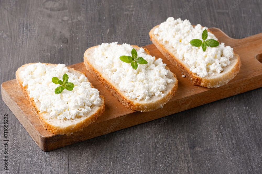 Bread with curd cheese on wooden board Bread with curd cheese on wooden board