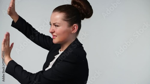 Beautiful girl with chignon makes repulsive motion