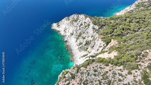 Aerial drone photo of scenic volcanic island rocky bay full of pine trees and beautiful emerald crystal clear sea in tropical exotic destination