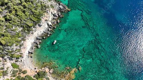 Aerial drone photo of scenic volcanic island rocky bay full of pine trees and beautiful emerald crystal clear sea in tropical exotic destination