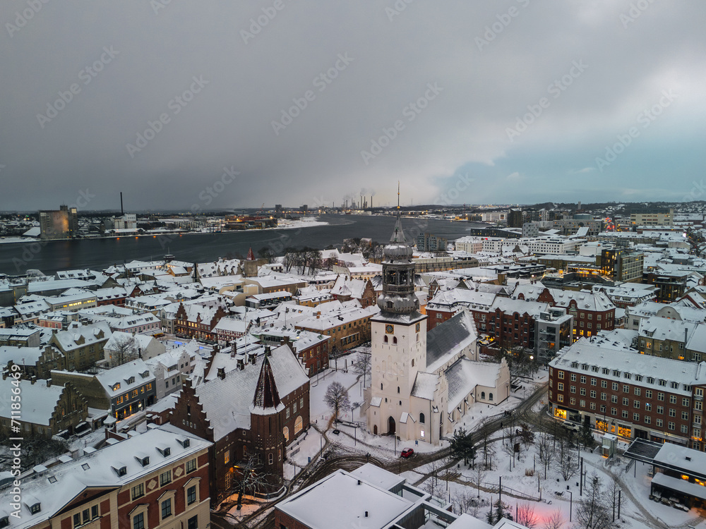 Aerial winter skyline panoramic view of Aalborg covered with snow. Old town with the Budolfi Church (Budolfi Kirke). North Jutland, Denmark
